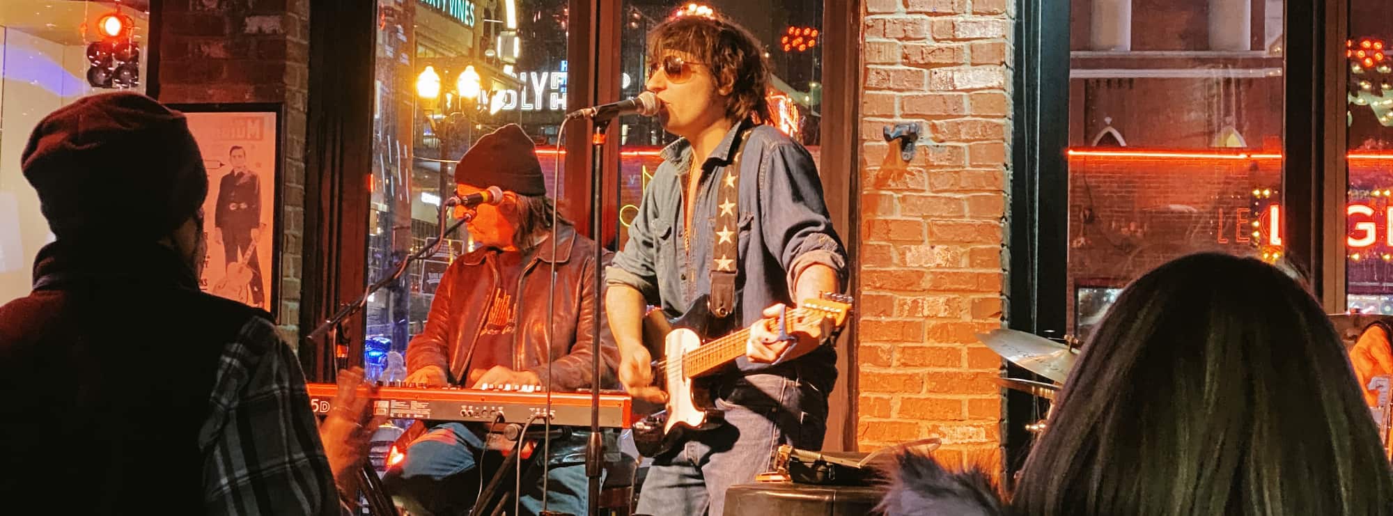 bar singer on guitar in State College