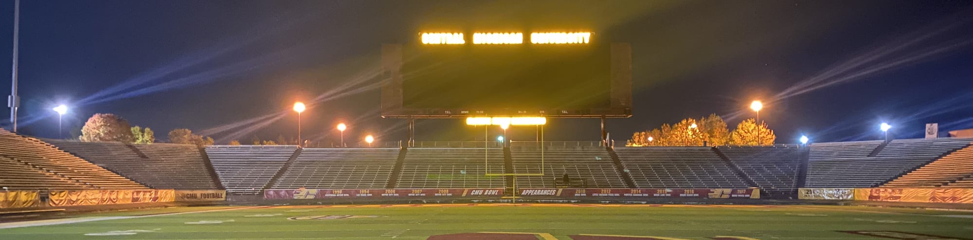 empty football stadium at night under the lights State College